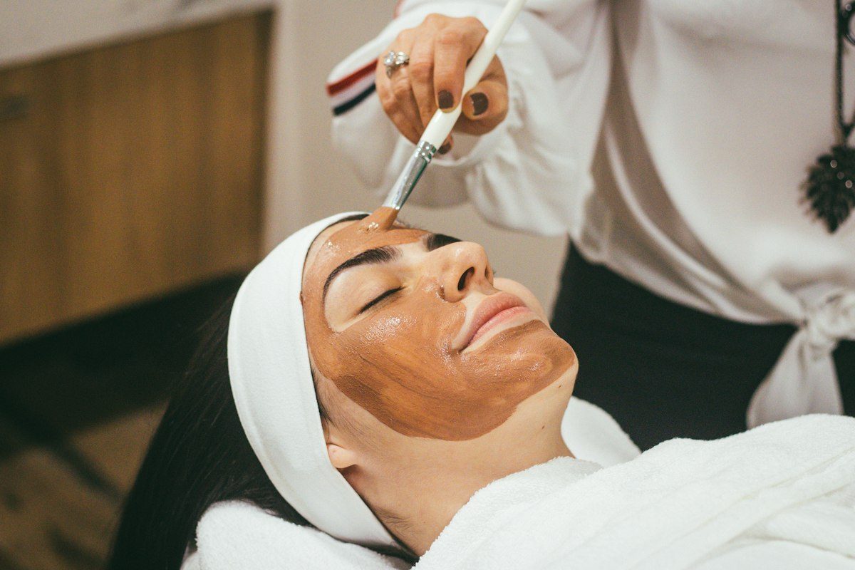 A client relaxing during a facial treatment